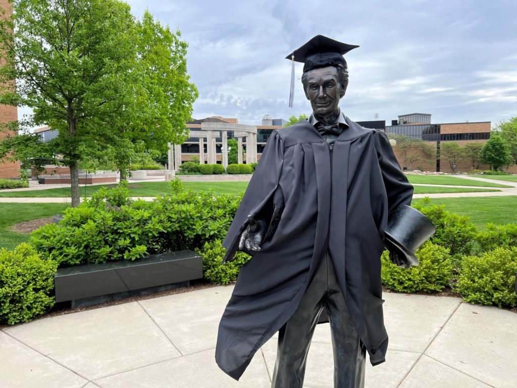 Abe on UIS Campus with graduation garb on CREDIT: UIS Facebook