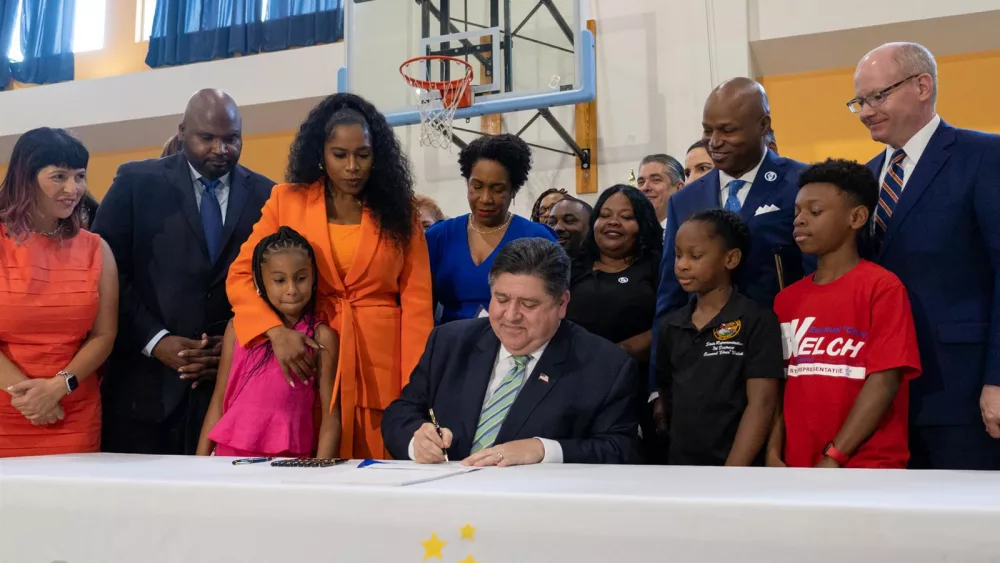 Gov. JB Pritzker signs the Fiscal Year 2024 state budget into law Wednesday. (Capitol News Illinois photo by Andrew Adams)