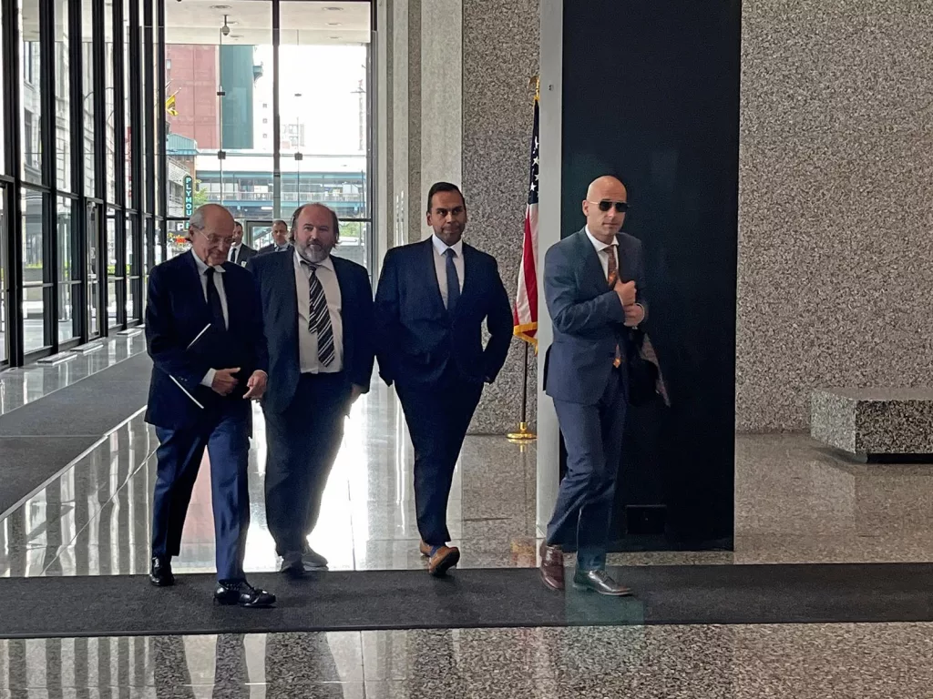 Businessman James Weiss, second from left, exits the Dirksen Federal Courthouse in Chicago with his lawyer and others after being found guilty on public corruption charges. (Capitol News Illinois photo by Hannah Meisel)  