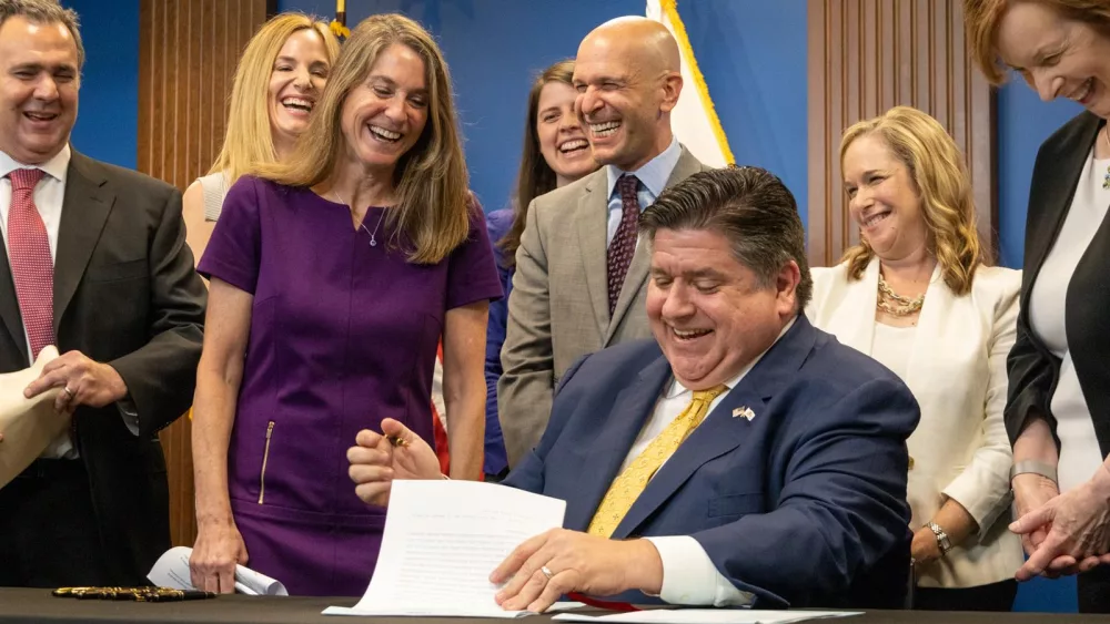 "Oh, I’m signed!” exclaims Sen. Laura Fine, D-Glenview, as she realizes that her bill giving the Department of Insurance new oversight authority had been approved by Gov. JB Pritzker. (Capitol News Illinois photo by Andrew Adams)