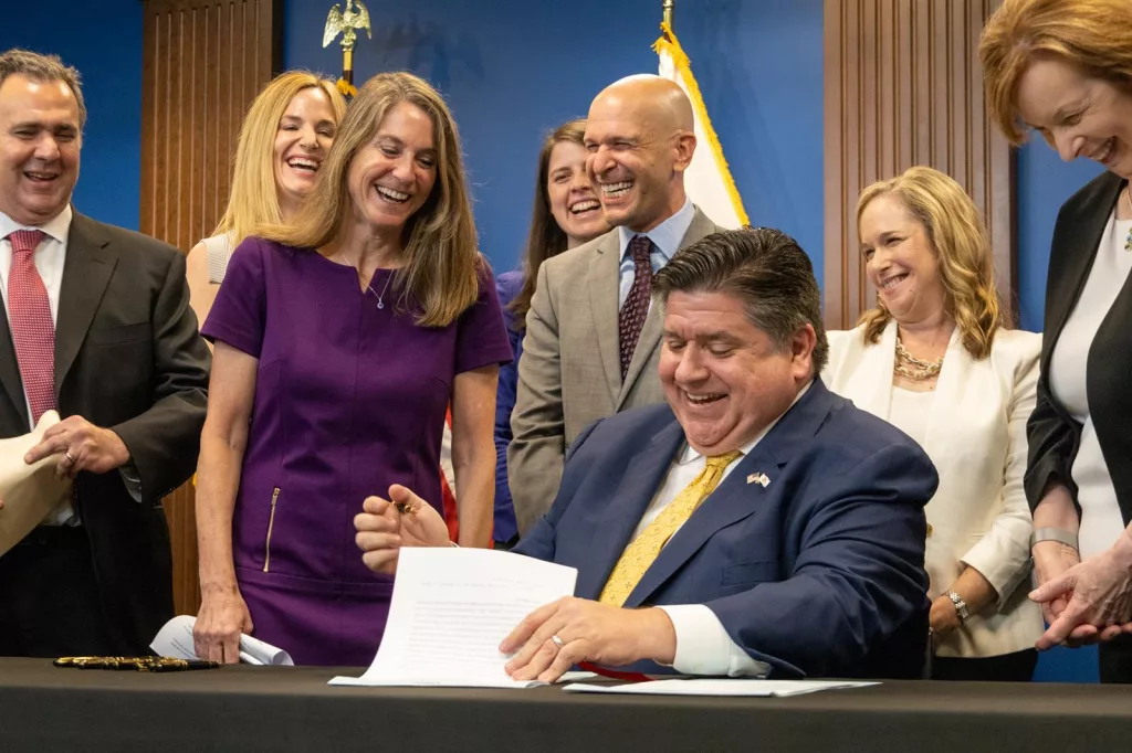 "Oh, I’m signed!” exclaims Sen. Laura Fine, D-Glenview, as she realizes that her bill giving the Department of Insurance new oversight authority had been approved by Gov. JB Pritzker. (Capitol News Illinois photo by Andrew Adams)