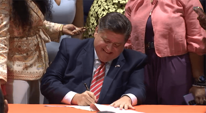Gov. JB Pritzker signs a bill overhauling the state's mandatory supervised release program for former inmates who have completed their prison sentences. (Credit: Illinois.gov)