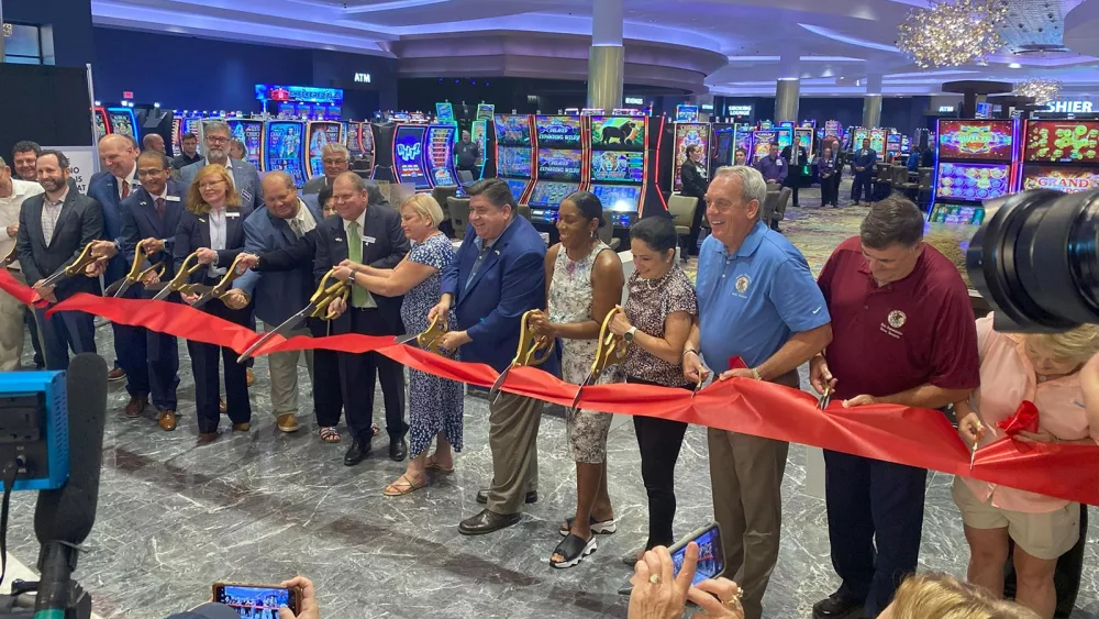Gov. JB Pritzker (center) is joined by state and local leaders to cut the ribbon on Walker’s Bluff Casino and Resort on Friday, Aug. 25, 2023. (Capitol News Illinois photo by Jennifer Fuller)