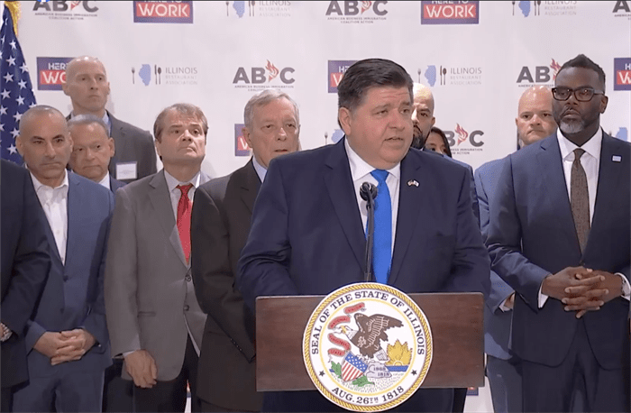 Gov. JB Pritzker at a Chicago news conference Wednesday, advocating for the federal U.S. Department of Homeland Security to allow Illinois and other states to sponsor work permits for asylum seekers and other long-term undocumented workers. (Screenshot via Illinois.gov)