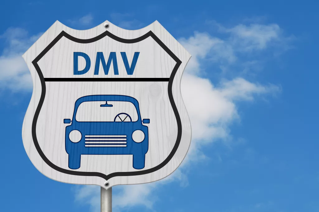 Visit to the DMV Highway Sign, Icon of a car and text DMV on a highway sign isolated with sky background
