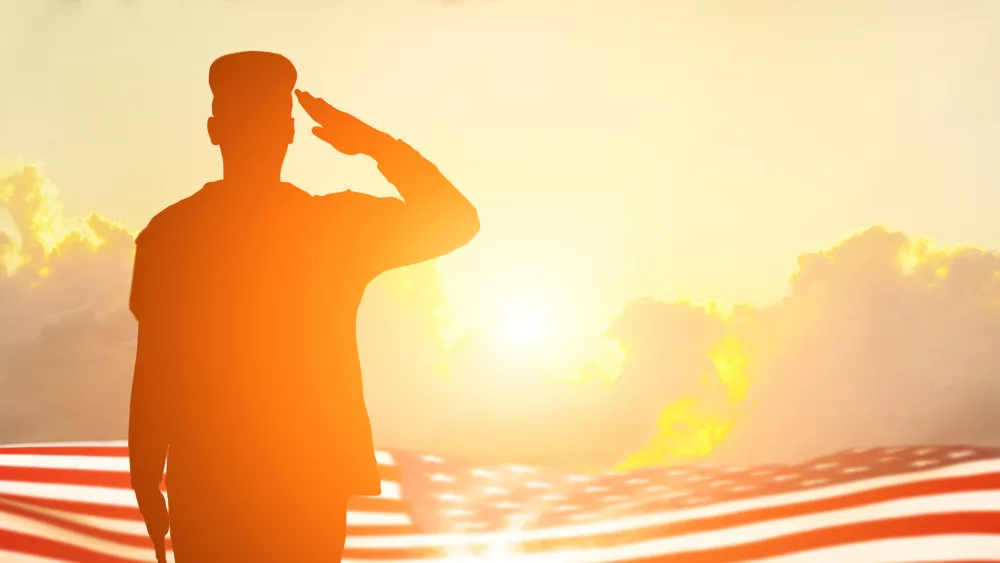 Soldier and USA flag on sunrise background .Concept National holidays , Flag Day, Veterans Day, Memorial Day, Independence Day, Patriot Day.