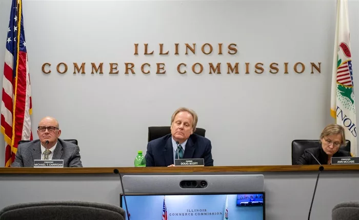 Illinois Commerce Commission member Michael Carrigan (left), Chair Doug Scott, and member Ann McCabe are pictured at a commission meeting in Springfield earlier this month. (Capitol News Illinois photo by Jerry Nowicki)