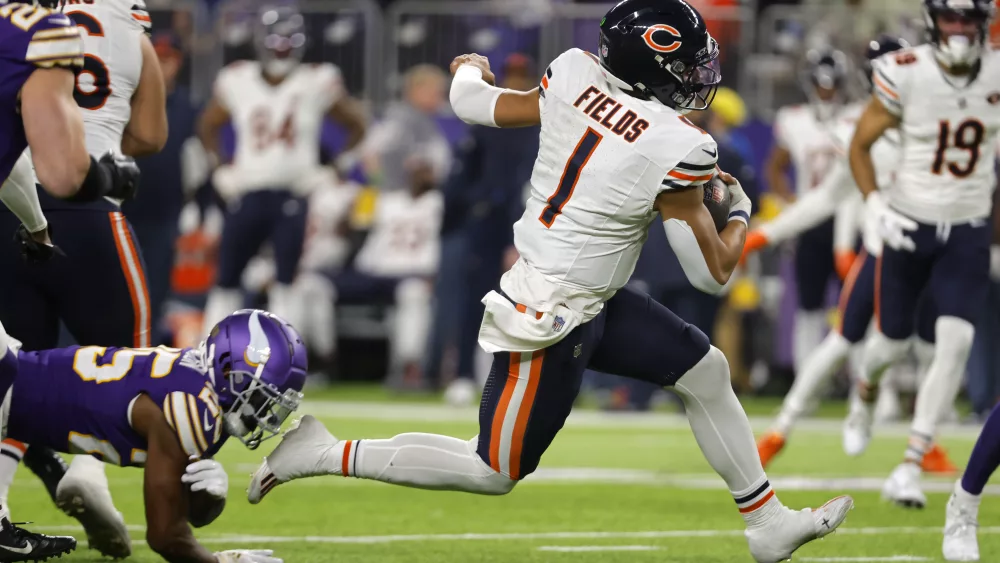 Chicago Bears quarterback Justin Fields (1) runs up field during the second half of an NFL football game against the Minnesota Vikings, Monday, Nov. 27, 2023, in Minneapolis. (AP Photo/Bruce Kluckhohn)