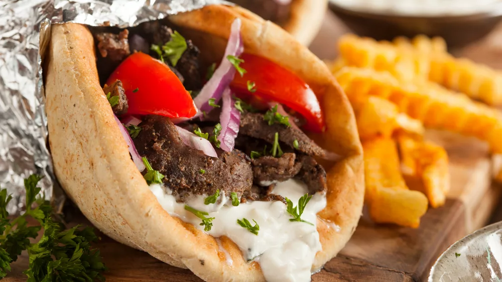 Homemade Meat Gyro with Tzatziki Sauce, tomatos and French Fries