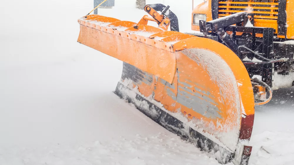 Snow plow doing snow removal after a blizzard in Chicago suburb.