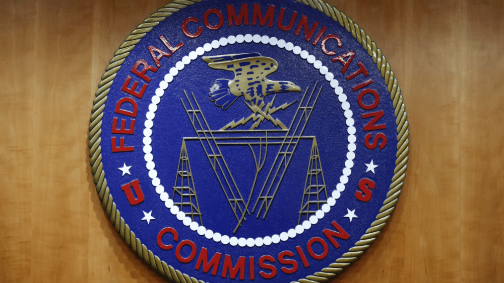 FILE - The seal of the Federal Communications Commission (FCC) is seen before an FCC meeting to vote on net neutrality, Dec. 14, 2017, in Washington. The Federal Communications Commission is outlawing robocalls that contain voices generated by artificial intelligence. The decision sends a clear message that exploiting the technology to scam people and mislead voters won’t be tolerated. (AP Photo/Jacquelyn Martin, File)