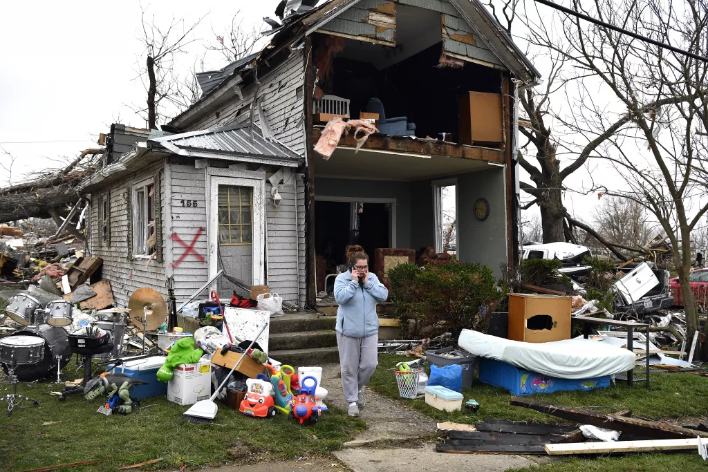 Brittany Oakley checks in with relatives outside of what is left of her home in Lakeview, Ohio., Friday, March 15, 2024. Severe storms with suspected tornadoes have damaged homes and businesses in the central United States. (AP Photo/Timothy D. Easley)