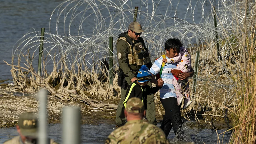 Migrants are taken into custody by officials at the Texas-Mexico border, Jan. 3, 2024, in Eagle Pass, Texas. (AP Photo/Eric Gay, file)
