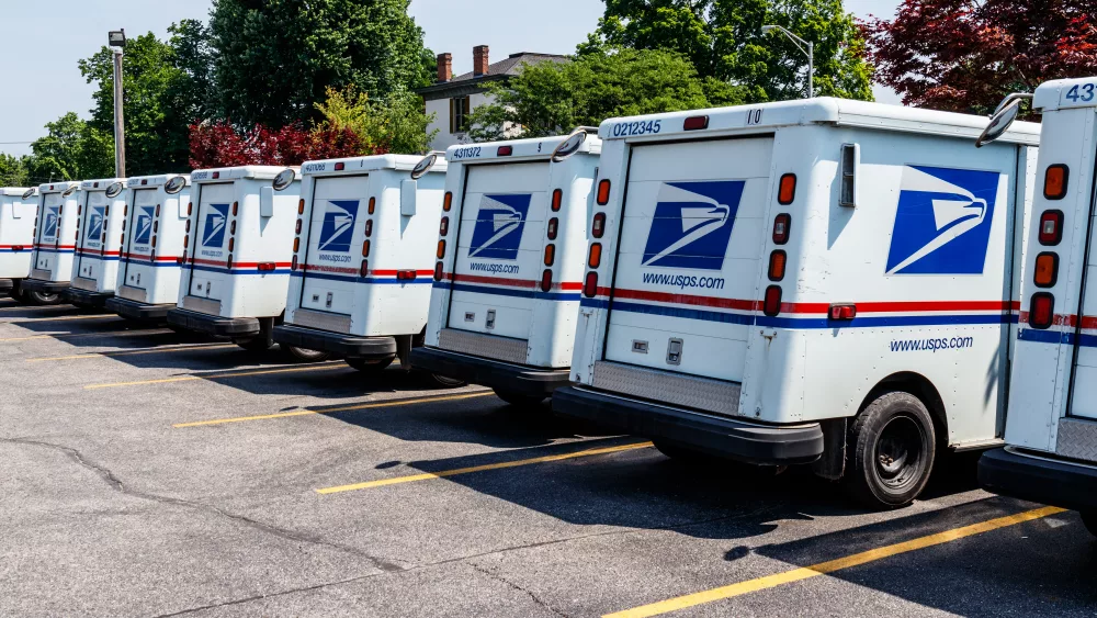 Logansport - Circa June 2018: USPS Post Office Mail Trucks. The Post Office is Responsible for Providing Mail Delivery IV