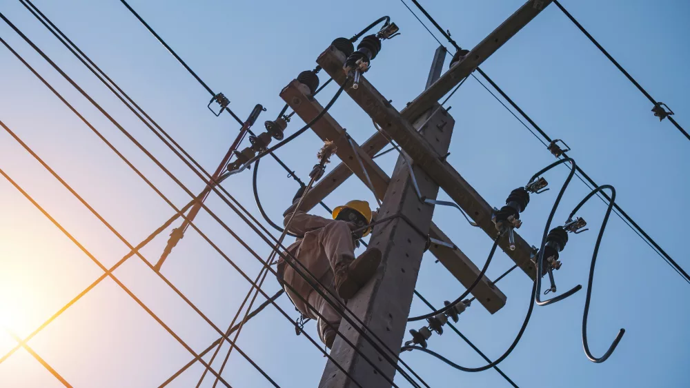 The power lineman uses insutated tool to open the connection of the transformer from the high voltage distribution system. To change the drop out fuse cut out that protects the transformer.