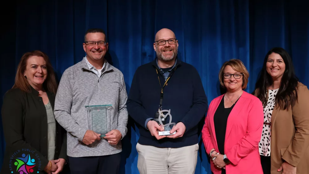 Jason Wind and Jason Potter (Left to right) receiving their Horace Mann awards for 2024 with Superintendent Jennifer Gill, Horace Mann CEO Marita Zuraitis, and Katie Hageman (Credit: District 186 Facebook)