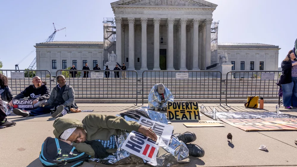Activists demonstrate at the Supreme Court as the justices consider a challenge to rulings that found punishing people for sleeping outside when shelter space is lacking amounts to unconstitutional cruel and unusual punishment, on Capitol Hill in Washington, Monday, April 22, 2024. (AP Photo/J. Scott Applewhite)