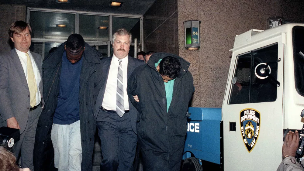 FILE - In this April 22, 1989 file photo, Yusef Salaam, 15, second from left, and Raymond Santana, 14, right, are led from the 24th Precinct by a detective after their arrest in connection with the rape and severe beating of a woman jogging in Central Park. Donald Trump was found guilty in same courthouse where five Black and Latino youths, including Salaam and Santana, were wrongly convicted 34 years ago in the 1989 vicious attack on a white female jogger. The former president famously took out a newspaper ad in New York City calling for the execution of the accused, in a case that roiled racial tensions locally and that many point to as evidence of a criminal justice system prejudiced against defendants of color. (AP Photo/David Burns, File)