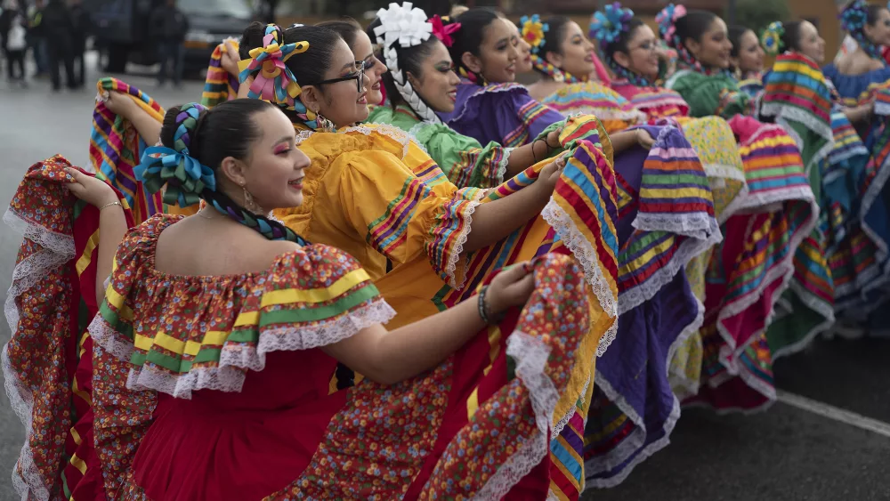 FILE - Members of the Cathedral City High School Ballet Folklorico pose for photo prior to joining in the Kingdom Day Parade in Los Angeles, Jan. 16, 2023. (AP Photo/Richard Vogel, File)