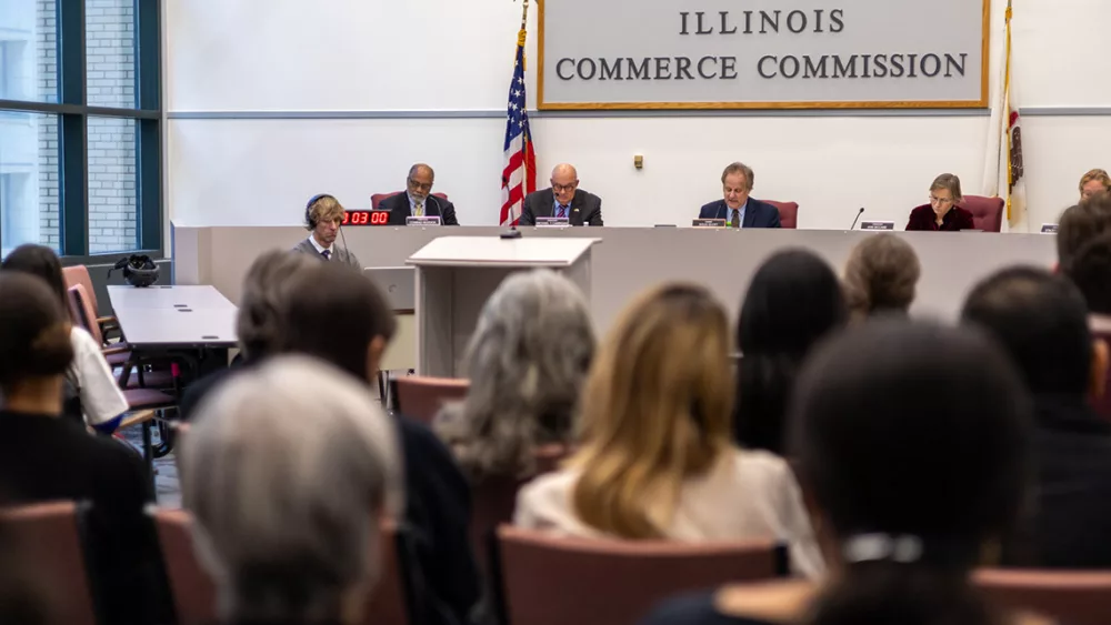 Illinois Commerce Commission Chair Doug Scott (third from left) reads a 2023 decision rejecting grid plans from Commonwealth Edison and Ameren Illinois. Revised versions of those plans were approved Thursday. (Capitol News Illinois photo by Andrew Adams)