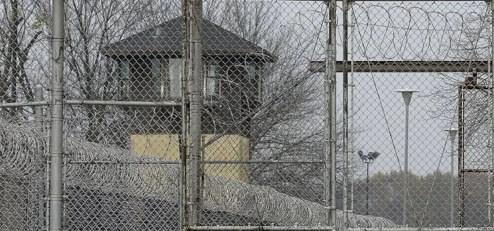 FILE - Security fences surround the Illinois Department of Corrections' Logan Correctional Center on Nov. 18, 2016, in Lincoln, Ill. A report Tuesday, Sept. 20, 2022, by a state inspector general found that an Illinois prison system administrator improperly ordered the hiring of a family member for a Department of Corrections position that was never authorized. (AP Photo/Seth Perlman, File)