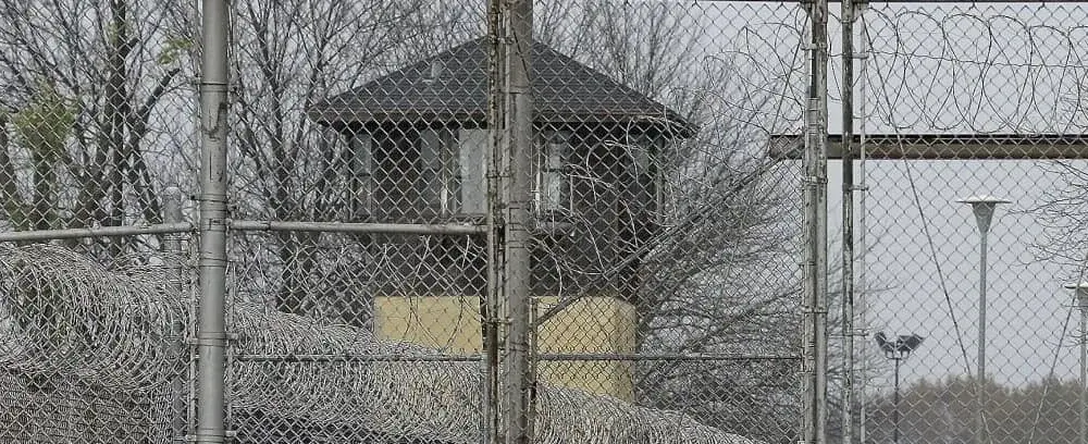 FILE - Security fences surround the Illinois Department of Corrections' Logan Correctional Center on Nov. 18, 2016, in Lincoln, Ill. A report Tuesday, Sept. 20, 2022, by a state inspector general found that an Illinois prison system administrator improperly ordered the hiring of a family member for a Department of Corrections position that was never authorized. (AP Photo/Seth Perlman, File)