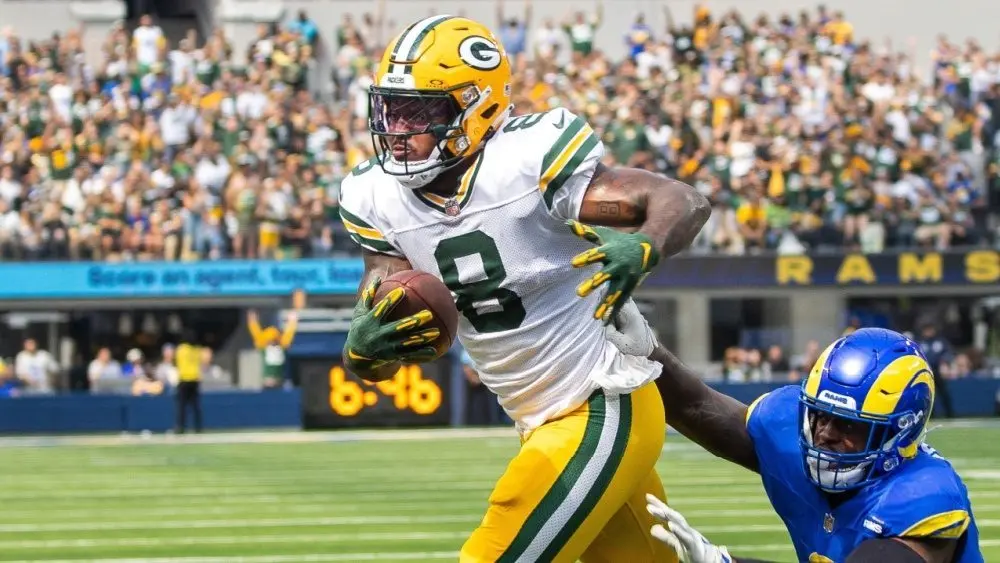 Green Bay Packers running back Josh Jacobs #8 runs past Los Angeles Rams outside linebacker Jared Verse #8 for a touchdown during an NFL football game at SoFi Stadium^ Sunday^ Oct. 6^ 2024.