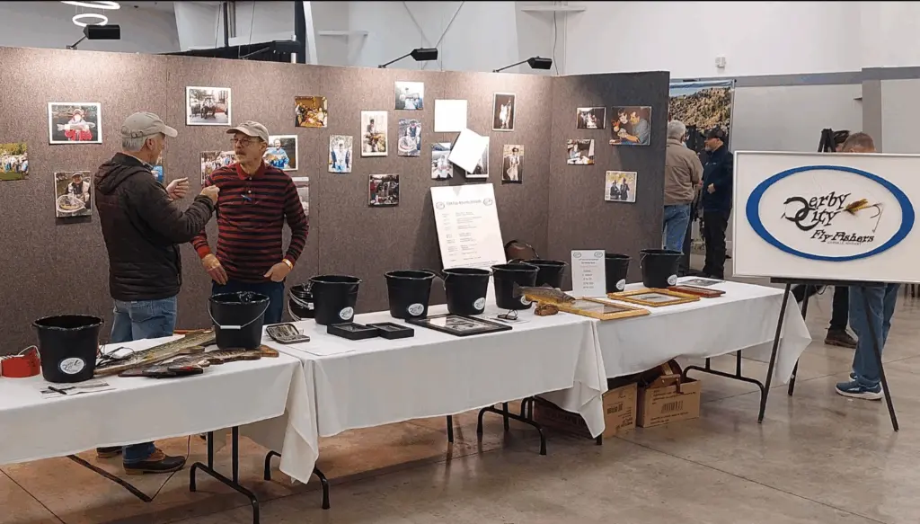 Two men conversing at a previous Kentuckiana Fly Fishing show