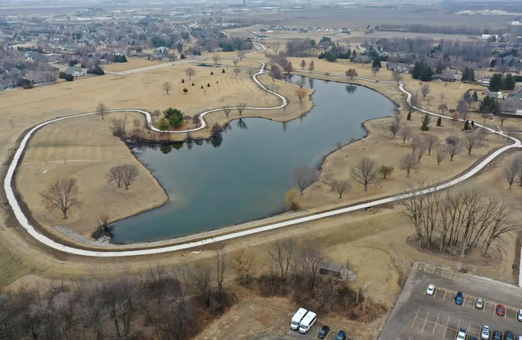Ready for spring to arrive? So is the city of Peru. A little sunshine and some warm temperatures will help workers finish the walking path at Baker Lake.In a Thursday update, Peru Mayor Ken Kolowski said the project isn’t behind schedule, but it is weather-dependent and will resume in earnest when spring has finally sprung.“We’re waiting for the weather to break to finish up details and landscaping this spring,” Kolowski said. “It depends on Mother Nature.”As previously reported, the Peru City Council awarded a pair of bids to replace the multi-use path at Baker Lake. The base bid of $253,639.75 was awarded to Gillan Construction as was an alternate bid of $40,212.76.Parks director Adam Thorson had estimated the path is at least 30 years old. City engineer Eric Carls said the project is to remove the asphalt path and replace it with concrete, with an additional path to the forthcoming parking lots. The alternative bid is to expand the path from 8 feet to 10 feet. Secondary concrete paths will connect the new parking lot near Lighted Way to the parking lot, playground, and shelter on the west side of Baker Lake.