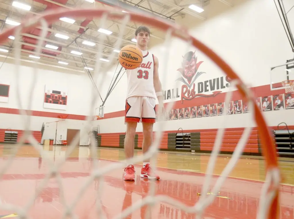Braden Curran had heard all the stories.His dad, Adam, was a member of Hall’s two greatest basketball teams, which were a whisker from winning back-to-back state championships in 1996-97 and 1997-98, finishing as two-time state runners-up.The elder Curran, who now goes by the title of Spring Valley Police Chief, was a key member of Eric Bryant’s Hustlin’ Hall Red Devil teams. He was known for his high energetic play and rebounding prowess, nicknamed the “Worm” after the NBA great of the time, Dennis Rodman.Braden Curran, a Hall senior, plays a lot like his dad, running on high energy, playing all-out defense (area-high 2.6 steals per game) with an ability to hit the boards (6.4 rebounds a game).But he’s added an extra dimension to his game - scoring - that his dad didn’t need playing with All-Stater Shawn Jeppson. Braden scored his 1,000th career point this season, averaging 14.8 points per game on the year, shooting 33% on 3-pointers and area-best 50% overall from the field. He’s found the offensive part of his game to come natural.“When we were young, I was taller than everyone. It was easy just to score and I kind took that with me and learned different skills,” he said. “I guess you can say I’m an offensive player, but I still have that ‘Worm’ in me, I guess, just playing both sides of the ball, and doing what you’ve got to do.”That work ethic led Curran to garner unanimous Three Rivers East All-Conference and IBCA Class 2A Special Mention All-State. For all of his accolades, Curran has been named as the 2025-26 BCR Boys Basketball Player of the Year. Curran, who is the first Red Devil named since Drew Pullam in 2016, said it’s pretty cool to receive the player of the year honor.“It was a very fun season. I’ve had fun playing basketball the last four years here at Hall,” he said. “All the thanks to everyone who’s helped me, my parents, my coaches, my teammates.”Hall coach Mike Filippini said Curran is one of the hardest working and more importantly hardest playing kids he’s ever coached in his 25 years at Hall. “He always gave us everything he had. We never had to worry about effort from Braden,” Filippini said. “He was always undersized for the position he played, which was small forward, always had to guard a player much bigger than him and always was guarded by a bigger player. “Most players that are 6-1 play point guard in high school, but Braden had to play center, power forward or whatever position we needed him to play. He never complained about it, just was willing to do whatever it took to help the team.”Curran took it upon himself to be a team leader for the Red Devils this season.“I’m a senior. I’ve played varsity four years. I knew I kind had to be a leader, but the rest just comes natural and when you have guys who have faith in you it’s easy to play,” he said.“It’s about coming in every day in practice, just pushing other guys to work hard. Do things the right way. Coming in over the summer when you didn’t have to, Coming over the weekends when there’s no practice just working with guys that need work.”The strength of his game, is “definitely my speed,” he said.“Just getting to the hoop, getting downcourt. Even working hard, I can run so I can endure and that’s something that’s kind of always helped me,” he said.He’s never found the need to be motivated.“Motivation has always been some that’s kind of built in me,” he said.Curran does hear the stories of the good old days from his dad’s Red Devils teams, but there is a purpose behind it.“He always uses it as a teaching point,” he said. “He likes to tell stories. They had a great chemistry. I know that. I’ve talked to (Hall football) coach (Nick) Sterling. I’ve talked to (dad) and Mr. (Hall athletic director Eric) Bryant, Jeppson, all those guys. It’s inspired me at least to build a chemistry with all my teammates in every sport, not just in basketball.”Curran said he’s had lot of great memories playing basketball for the Red Devils. This year getting to play for the Colmone Classic championship stands out.“Making it to the Colmone Classic championship, which obviously is the big tournament to all of us,” he said. “Beating Fieldcrest the night before. Having to play a week later (due to a weather postponement), but still huge for us. We wanted to play in that game and got in that game.”And he could’t have asked for a better way to score his 1,000th-point basket at home against rival St. Bede on an an assist from his twin, Jack.“It’s pretty awesome how that worked out. Storybook way to do it,” he said.Filippini said Curran has been a great role model for the kids in the Hall community.“On top of his basketball skills, Braden was also a great leader both on and off the court,” he said. “Braden always volunteered his time to work our youth basketball camps in the summer. The younger kids would always look up to him. Braden is definitely deserving of this award and he deserves all the praise he’s been getting.”