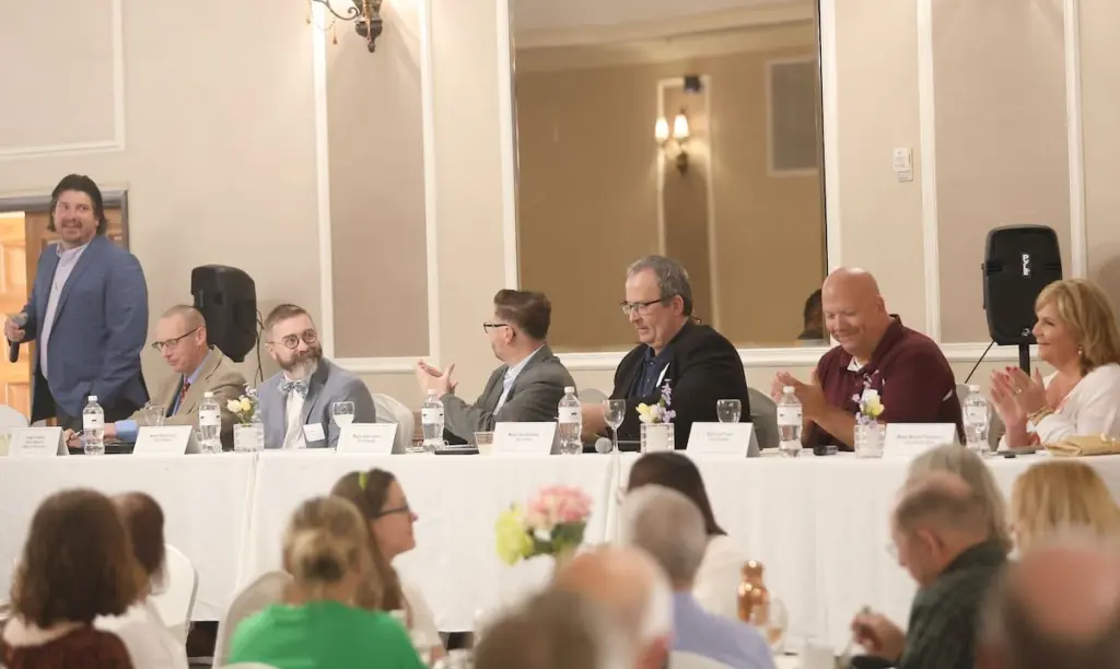 The mayors of North Utica, La Salle, Peru and Spring Valley appeared at the 2026 State of the Cities Luncheon to provide residents with a review of the year’s progress, an update on the state of current projects, the status of future initiatives and plans for continuing to improve the Illinois Valley region.In a discussion moderated by outgoing Illinois Valley Area Chamber of Commerce CEO Bill Zens, the mayors spoke about acquiring resources, improving public spaces and garnering attention for their municipalities.Utica mayor Dave Stewart spoke about the Market on Mill, a retail plaza that serves as a launchpad for small businesses in the village.“It’s the most popular topic that I’ve probably covered over the last couple of years here,” he said. “This year, I get to talk about the functionality of it versus the actual building.”Stewart was pleased with the first year of the plaza, while acknowledging that there’s room for improvement in 2026 and beyond.Stewart also discussed the future addition of sidewalks, crosswalks and lighting on the sound end of the village along the west side of Route 178 from Johnson Street to the police station, thanks to funding from an Illinois Transportation Enhancement Program grant. The project will begin in 2027 or 2028, and accomplish something the village had been trying to get done for 15-20 years.Also in Utica’s future is an I&M Canal project that Stewart said is currently in the permit phase.“We’re trying to take a section of the canal within the city limits of Utica to build two temporary sandbag berms and filling it with storm water runoff from all the streets and municipal water, and add to get it to a certain level that they think will kill off the vegetation there,” he said.Peru Mayor Ken Kolowski shared a pair of additions the city made in 2025 as the biggest updates for this year’s State of the Cities address.The city added chillers at the Schweikert Arena ice rink and a concrete path at Baker Lake. The chillers helped double the length of the skating season for patrons. “It was nice to see a lot of kids and families,” Kolowski said. “When you have ice skating and a winter activity like that for the whole entire winter, we didn’t have to worry about Mother Nature.”The new concrete path at Baker Lake was completed last week after beginning in October 2025, although Kolowski said the path is just the beginning for Baker Lake.“The path has been going over fantastic,” he said. “We’re going to continue to grow Baker Lake. We want to stock it with fish, we want to beautify it.”Kolowski said the biggest economic development of the year for Peru was the $100 million expansion of the Eakas Corporation in the city. The automotive supplier is constructing a new 280,000 square foot multi-level industrial warehouse, which Kolowski said will bring in about 100 jobs.“It’s very exciting,” he said. “Any time a company can expand like that, it’s good for everybody.”Kolowski looked into the future with a pair of projects, the Connect 138 initiative and the sports complex, to help the city of Peru. Connect 138 is a $20-25 million project to enhance the Peru power and generation system in the hopes of attracting more business.“I think all the mayors can agree that one of the biggest challenges right now is power,” he said. “Everybody wants these factories and things like that, but if somebody comes into town and you don’t have the power to do it you have to tell them no.”Kolowski said that Peru is pushing hard for a sports complex, and taking steps to make it happen.“We’re continuing to pursue the sports complex. We sent our team last year to the biggest Vegas retail show just to go out and feel it out. This year we’re taking a book in a booth,” he said. “We’re doing everything. We’re going to put the Illinois Valley on the map. We’re going to sell Peru in this region really hard. This would change the entire region. Everybody will benefit for something like this.”La Salle Mayor Jeff Grove emphasized the city’s motivation to connect people in more ways than one.He celebrated the settling of four union contracts in the city before the April 30 deadline.“This is important to me,” he said. “I think it’s important to show respect for the groups that we work with.”Grove spoke candidly about La Salle’s issue with fiber optic, as it experiences hang-ups with the Environmental Protection Agency clean-up in town.“Some yards are being mitigated, some yards have been mitigated,” he said. “We appreciate that we have a relationship with the EPA and when we get the information, we can share that with a potential vendor.”Grove also outlined a plan for the site of the Kaskaskia Hotel, which is a shift from prior stated plans by the city.“Just for the record, I want that Kaskaskia down,” he said. “I want a nice green spot in the middle of town where we can have our events.”Grove acknowledged the need for partnership with the hotel’s ownership in making that happen.“As CL Industry is trying to come up with a plan for the Kaskaskia, we as the city are going parallel through litigation to hopefully get control of that property,” he said.Grove highlighted a city initiative for the community to spend at local businesses, La Salle Bucks.“La Salle Bucks are basically like a gift card for La Salle businesses and I’d say probably 95% of our businesses are on board with it,” he said. “You try to keep it local, which is what we’re all trying to do.”Spring Valley Mayor Melanie Thompson noted the year of progress her municipality had in the form of projects, grants and community safety.The main project was the Spring Valley Community Event Center, which Thompson said was emblematic of the collaboration of people for a communal purpose.“I don’t see projects completed. I see people coming together,” she said. “What began as a vision, even after facing setbacks, became a reality because this community refused to give up.”Thompson cited local fundraising, volunteer efforts and resident support as keys to helping realize the potential of the community center.“We created something far greater than a building,” she said. “We created a space for connection, a place where you can grow, families can gather and where our community can stand together.”Along with the event center, several public spaces were buoyed by projects supported by grants in Spring Valley.One such space was the mini-park, which added new concession stand space with public restrooms, outdoor dining seating and a fire pit with chairs and tables, all donated by members of that community.“That space quickly became a gathering place during our summer events,” Thompson said. “It was filled with families, laughter and connection.”Downtown Spring Valley may get spruced up in the near future after Thompson announced that plans are in the works to use a $695,000 Downtown Revitalization Grant on enhanced downtown lighting, a bandstand expansion, sidewalk improvements and improved parking.“This is more than an infrastructure,” she said. “This is about creating a downtown where people want to gather, where businesses can grow and where our community can come to life.” Kirby Park saw several improvements in the last year and will continue to be an area of focus for Spring Valley.“We networked with Hall High School and volunteer community members, and we were able to completely renovate the field,” Thompson said. “We have new fencing, a new grass infield and an irrigation system.”Between an OSLAD grant in 2024 and a $245,000 grant, Spring Valley is going to develop a new baseball and softball diamond, as well as purchase additional land to create a multi-field complex with parking and concessions.Thompson was able to announce that residents will be helped more directly thanks to a $650,000 Community Block Grant, aimed at rehabilitating low-income housing, the third such grant Spring Valley has received.“These allow us to take certain sections of town with lower-income areas, and they’ll come in and completely rehab those houses for citizens that can’t afford to do so,” she said.