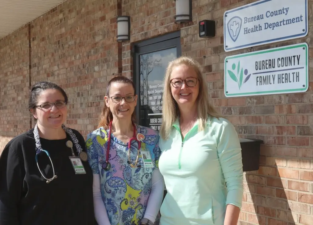 As rural areas across the country continue to lose access to obstetric and women’s health services, leaders at the Bureau County Health Department say their newly established family health clinic is proving local health departments can help fill the gap and potentially serve as a model for communities across the state.The Bureau County Family Health Clinic, which opened in April last year, was created specifically to address growing concerns surrounding women’s health access in Bureau, Putnam and Marshall counties after years of hospital service reductions and provider shortages.“We felt that the health department needed to step up and take responsibility for local health,” Bureau County Board of Health chair Pat Schou said. “If you look at this area 10 years ago, we had three hospitals providing OB services. All of a sudden, it fell apart. And it’s not just happening here.”According to a 2025 study from the University of Minnesota School of Public Health, access to obstetric care in rural areas is declining significantly across the country. Between 2010 and 2022, seven states had at least a quarter of their hospitals stop providing obstetric services. By 2022, there were eight states where more than two-thirds of rural hospitals were without obstetric services.Schou, who has chaired the Bureau County Board of Health for about 30 years, said the clinic was born out of a community needs assessment and conversations with longtime women’s health providers about how rural communities could respond to declining care access.“We can’t always expect a large health system to fix everything,” Schou said. “We also have to know what our local needs are, and we have to be responsible locally.”The clinic now provides women’s healthcare, family planning, prenatal and postpartum care, gynecological services, primary care, immunizations and behavioral health support through a partnership with Arukah Institute of Healing.Angie Reidner, who has worked in women’s healthcare for four decades and as a midwife for 35 years, said the clinic was designed around “low barrier care” tailored to the realities of rural communities.“When you can include the family and the women’s healthcare together in one setting, you’re really providing comprehensive low barrier care,” Reidner said. “For rural women, that’s important because sometimes you’re traveling an hour, an hour and a half to get the care that you need.”Reidner said the clinic has focused heavily on prenatal and postpartum care, areas she believes have become increasingly vulnerable as rural hospitals have scaled back obstetrics programs.She added that postpartum care is often overlooked despite rising concerns nationwide surrounding maternal mental health and safety.“Unfortunately, one of the leading causes of mortality during the postpartum period is maternal suicide and violence,” Reidner said. “We really need to make sure that we are available and that we are seeing women after they have their babies easily, quickly and regularly.”According to Schou, the clinic started entirely from scratch – a challenge both she and Reidner acknowledged is one reason similar models have not become more common among local health departments.“This coming together was certainly not easy,” Schou said. “You have to set up a clinic, build consensus, get community support and have your board beside you.”Rather than relying on major grants, Schou said the health department used reserve funds and secured a $150,000 line of credit through county government to launch the clinic.“That just shows you how supportive the community was,” Schou said.The clinic has quickly grown since opening, with officials saying patient demand exceeded typical expectations for a startup rural practice.“We are full most days,” Reidner said. “From day one, we’ve seen a minimum of 14 to 16 patients a day. Usually, when you start a practice, you see two, maybe three patients a day if you’re lucky.”Schou said patients now come from roughly 50 ZIP codes throughout the region.The clinic’s leadership believes the model could eventually help shape rural health strategies elsewhere in Illinois and beyond. Schou said he has already presented on the clinic at a national conference and discussed the concept with state maternal health officials.“I hope they do look to model this,” Reidner said of other health departments. “We have to realize that our communities have to take care of our communities.”Looking ahead, Reidner said the clinic hopes to continue expanding community education, increase access to walk-in care for sexually transmitted infections and urgent women’s health concerns and reduce stigma surrounding issues such as substance use, violence and mental health.“We need to be very intent on meeting their needs for low-barrier care and non-stigmatizing care,” Reidner said.Schou said the long-term goal extends beyond their community and ties directly to the future healthcare of rural communities.“If we’re going to keep our rural communities viable, we have to have young families and we have to support and provide things they need,” Schou said. “People in rural areas deserve quality care.”
