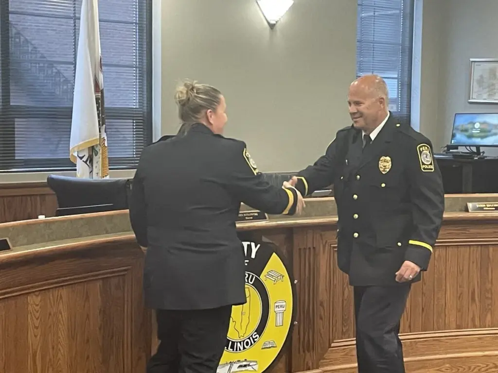 At age 56, he’s the oldest patrol officer at the Peru Police Department. Now, he’s a sergeant with no plans to retire any time soon.Bill Sommer was installed as patrol sergeant Monday before the Peru City Council, which applauded not only his promotion but also his rare longevity. “Bill Sommer loves being a police officer,” Police Chief Sarah Raymond said, introducing her newest sergeant to the council. “He has been doing this job for over 30 years and still is excited to come to work every day.“He is a unicorn when it comes to being a police officer.”Sommer had actually retired in 2019 as deputy chief of the Spring Valley Police Department, where he’d served 25 years, when he was asked to join Peru’s force. Sommer accepted and he’s still on patrol – and still enjoying it enough that he’ll stay on patrol while supervising his younger peers.“I’m honored, to be honest with you,” Sommer said. “I can mentor the young guys and that’s one of the reasons I took the test. I have a lot of mentoring to do.”The La Salle native studied at Illinois Valley Community College and then graduated from the University of Illinois Police Training Institute. Sommer was then sworn into the Putnam County Sheriff’s Office and took side jobs patrolling Lostant and Tonica.Then, he got a call from Doug Bernabei, who’d moved home from Florida to become police chief in Spring Valley. Bernabei invited Sommer to transfer to Spring Valley, where he spent the next 25 years.After a quarter-century at Spring Valley, Sommer was not burned out, but he had become pension-eligible for retirement and had recently become a grandfather. (He and his wife Amy currently await the birth of their eighth grandchild.)“I thought I was done. I retired. I thought I was just going to enjoy my life,” he said.But word circulated that a standout cop had a foot out the door, and Bernabei, at this time Peru’s police chief, got to him first.“The ink wasn’t dry on the pension papers, and the first call he received was from me,” Bernabei had previously said.Bernabei’s offer had come out of left field, but Sommer saw the wisdom in easing out of his dress blues. Since then, Sommer has passed Mark Credi for Peru’s in-house record for the oldest patrol officer. Sommer said he has no fixed retirement date.“I’ll know when,” Sommer said. “When God says it’s time, it’s time. I have no date on the horizon.”