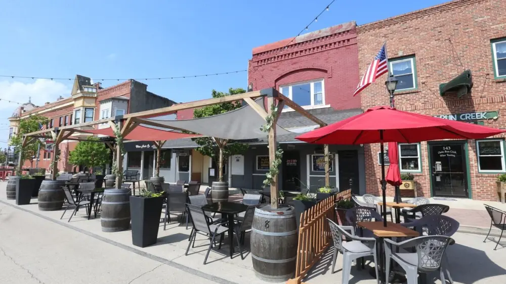 Outdoor dining in Utica has been a big hit, but Utica village officials say there are costs to the village and business owners must pay their fair share.