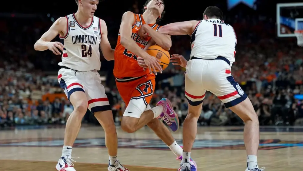 UConn got another critical 3-pointer from Braylon Mullins and coach Dan Hurley’s Huskies muscled their way back to the national title game, beating Illinois 71-62 in the Final Four on Saturday night as they seek their third championship in four seasons.
