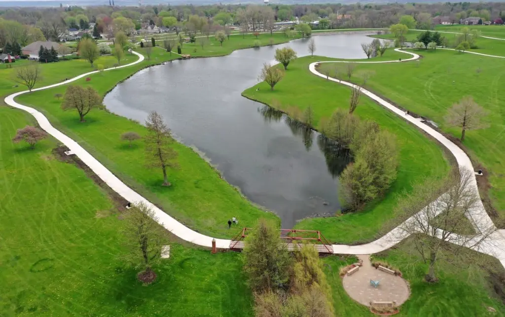 The new walking path at Baker Lake has been completed, and the park officially reopened to the public.  Construction on the project began last October and included the repaving of a 10-foot-wide concrete path, along with additional secondary paths. The improvements connect the new parking lot near Lighted Way to existing parking areas, the playground and the shelter on the west side of the lake.
The new main path is also two feet wider than the previous trail, providing more space for walkers and visitors. With the project now finished, the park is once again fully open for public use.
