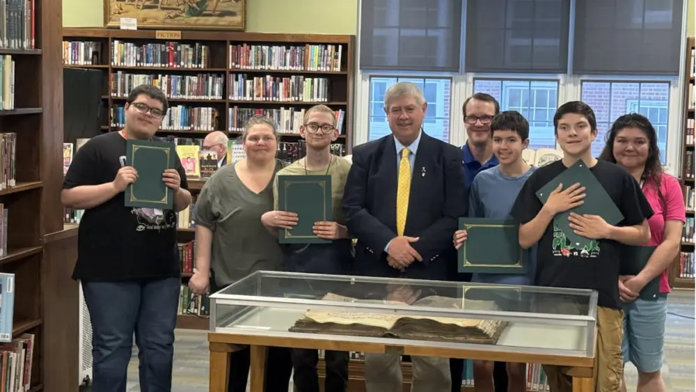 The athletes were recognized for qualifying in the snowshoe competition and the state basketball tournament with a certificate from Board President Greg Sarver.