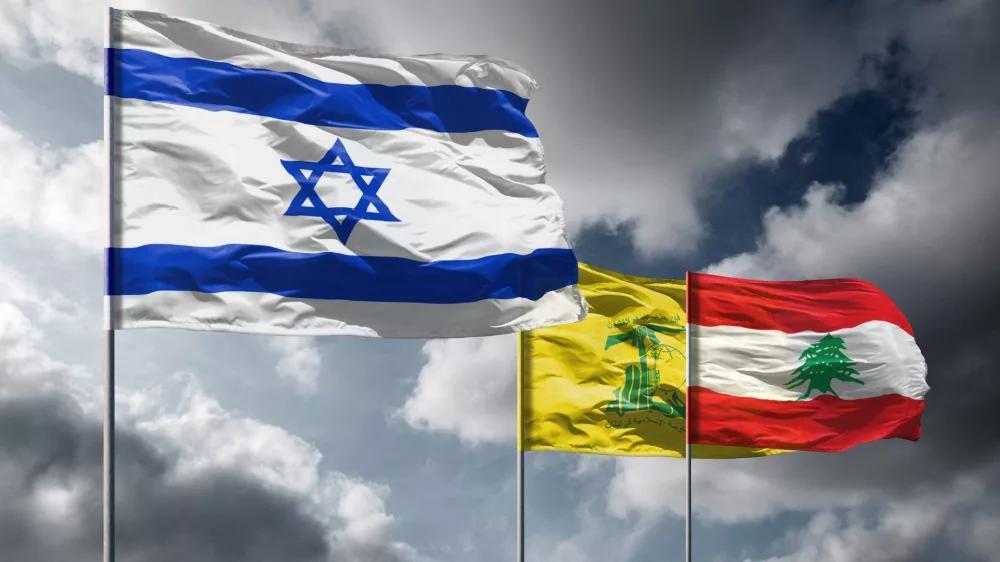 Flags of Israel above dark sky. Hezbollah and Lebanon flags in background