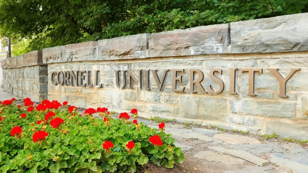 The entrance sign of Cornell University on campus of Cornell University. Cornell University is a private^ Ivy League university Ithaca New York - June 27^ 2021