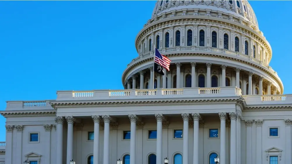 Close-up of the United States flag in front of the Capitol Building's dome in the morning^ Washington^ D.C.