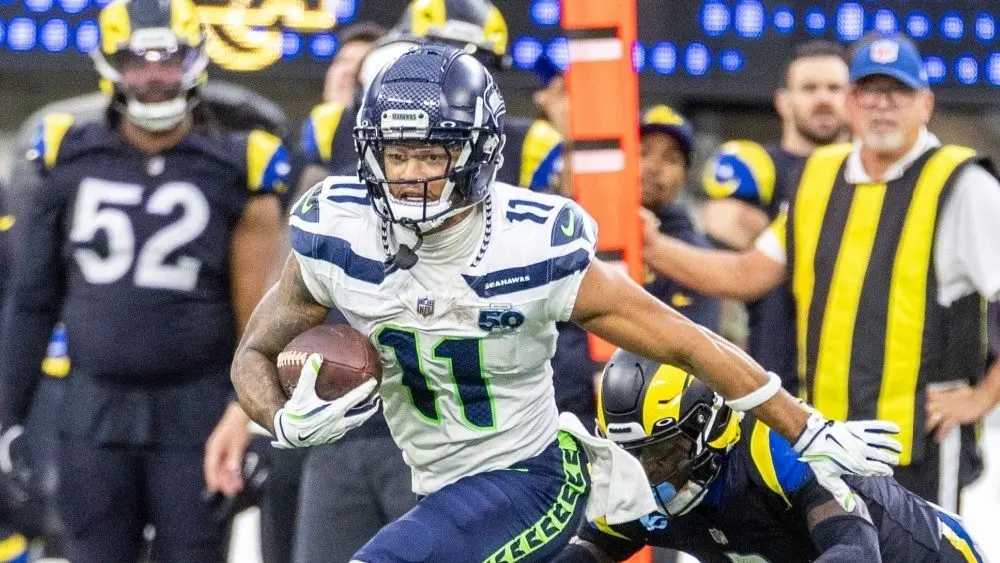 Seattle Seahawks wide receiver Jaxon Smith-Njigba (11) escapes a tackle-attempt by Los Angeles Rams cornerback Emmanuel Forbes Jr. (1) during an NFL football game Nov. 16^ 2025^ in Inglewood^ Calif.