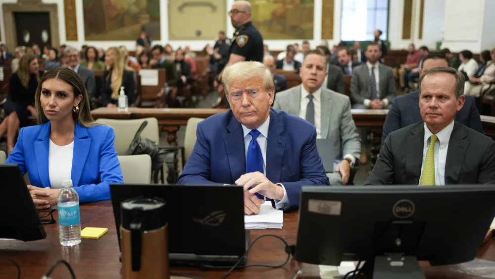 Former President Donald Trump, center, flanked by his defense attorneys, Alina Habba, left, and Chris Kiss, waits for the continuation of his civil business fraud trial at New York Supreme Court, Wednesday, Oct. 25, 2023, in New York. (AP Photo/Seth Wenig, POOL)