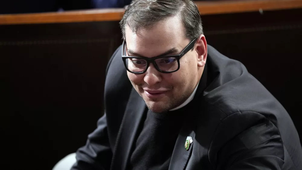 Rep. George Santos, R-N.Y., watches on the House floor at the Capitol in Washington, Oct. 25, 2023. Santos is set to be arraigned on a revised indictment accusing him of  several frauds, including making tens of thousands of dollars in unauthorized charges on credit cards belonging to his campaign donors. (AP Photo/Alex Brandon, File)