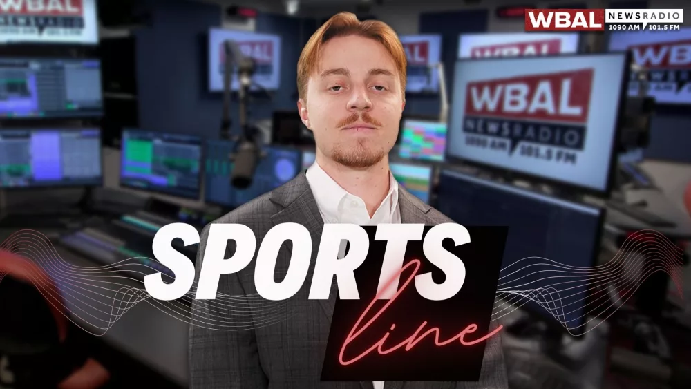 WBAL NewsRadio's Nick Testoni, reporter and host of Saturday's talk show, Sportsline. Nick stands in the WBAL Radio studio in a sports jacket with a straight face.