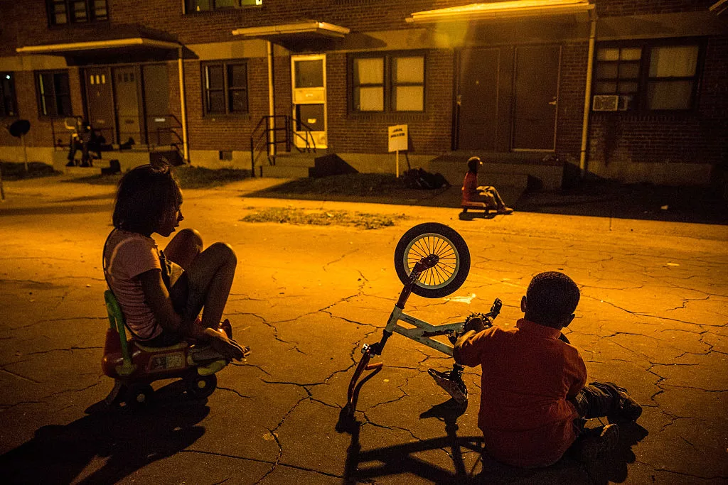 MAY 03: Children play at Gilmor Homes where Freddie Gray was arrested in the Sandtown neighborhood where he was arrested on May 3, 2015 in Baltimore, Maryland. Gray later died in custody; the Maryland state attorney announced on Friday that charges would be brought against the six police officers who arrested Gray. (Photo by Andrew Burton/Getty Images)