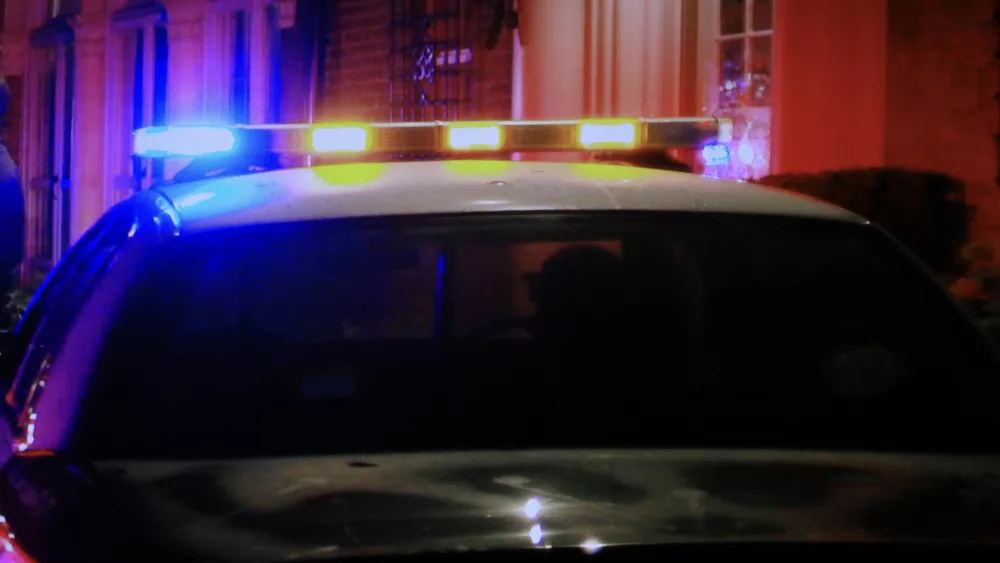 Police patrol lights flashing on car roof - stock photo