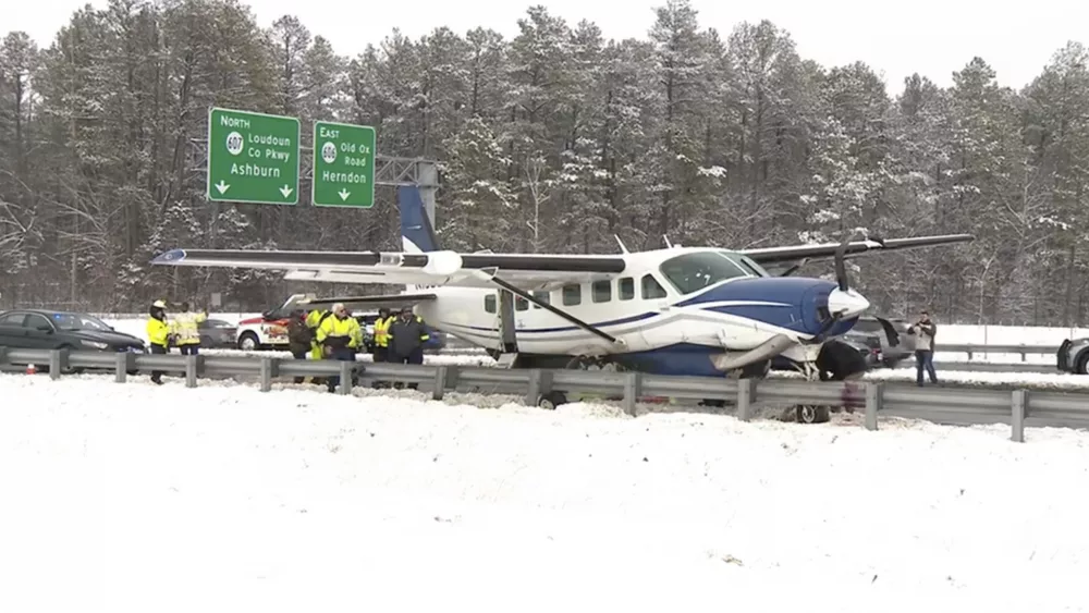 Emergency personnel investigate a small plane on a roadway in Loudoun County, Va., on Friday, Jan. 19, 2024. Authorities say the small aircraft made an emergency landing on a northern Virginia highway after taking off from nearby Washington Dulles International Airport. Virginia State Police say they received a call just before 1 p.m. Friday about a small aircraft making an emergency landing on Loudoun County Parkway. (WJLA via AP)