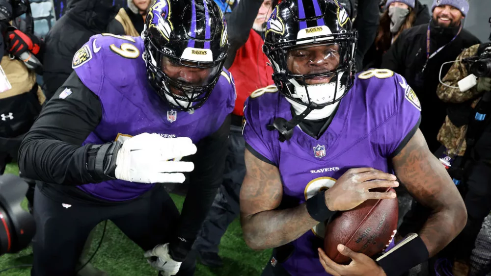 BALTIMORE, MARYLAND - JANUARY 20: Lamar Jackson #8 of the Baltimore Ravens celebrates with Ronnie Stanley #79 after scoring an 8 yard touchdown against the Houston Texans during the fourth quarter in the AFC Divisional Playoff game at M&T Bank Stadium on January 20, 2024 in Baltimore, Maryland. (Photo by Rob Carr/Getty Images)