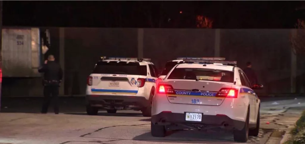 Image: Police cars in the dark, Credit: WBALTV. Story: Three Baltimore County police officers are suspended as they face charges over an alleged assault in Baltimore City. Baltimore City Circuit Court records show three officers are facing charges: Cpl. Zachary Small is charged with misconduct in office, first-degree assault, second-degree assault, reckless endangerment and violation of public safety. Officers Justin Graham-Moore and Jacob Roos are charged with misconduct in office. All three officers are suspended, 11 News Investigates learned on Friday.