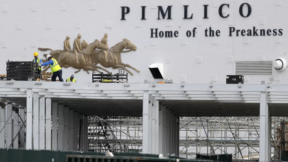 FILE - A crew works on putting up a platform near the main entrance at Pimlico Race Course, May 15, 2020, in Baltimore. A new plan, released Thursday, March 14, 2024, to rebuild Baltimore's storied but deteriorating Pimlico Race Course and transfer the track to state control is making a late charge down the stretch of Maryland's legislative session. (AP Photo/Julio Cortez, File)